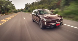 ภาพเต็มคันมุมหน้าเฉียงของ Volvo EX90 Twin Performance (2025) ขณะขับด้วยความเร็ว ซึ่งจากการใช้งานทั่วไปพบว่ามีอัตราการใช้พลังงานเฉลี่ย 19.7 kWh/100 กม. และแสดงระยะทางขับขี่ 542 กม. เมื่อชาร์จเต็ม 100%