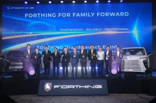 กลุ่มบุคคลร่วมถ่ายภาพบนเวที FORTHING Brand Launch Event ระหว่างรถ FORTHING สองคัน