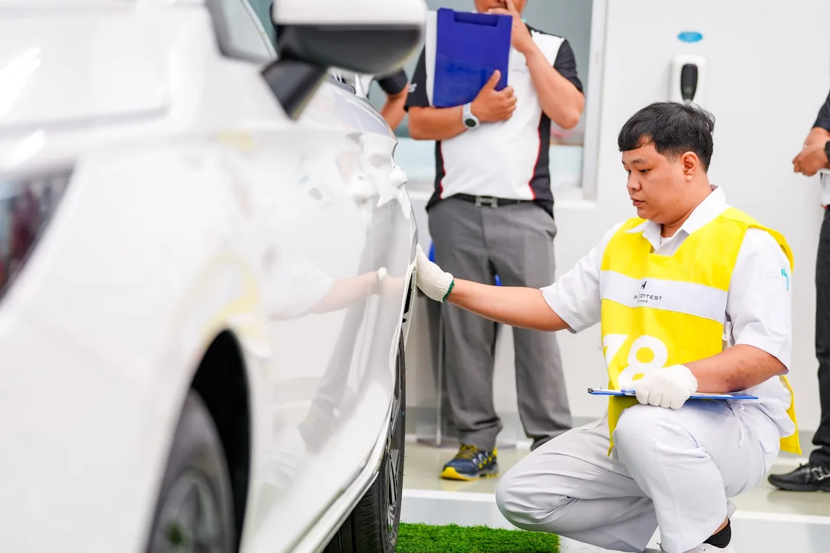 กิจกรรมตรวจสอบรถ Honda Skill Contest 2026 ผู้เข้าแข่งขัน Honda Skill Contest 2026 กำลังตรวจสอบรถบริเวณด้านข้าง พร้อมถือเอกสารบันทึกผล