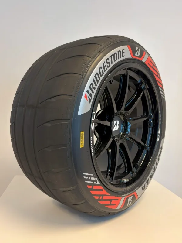 Bridgestone POTENZA GEN 4 ยางสำหรับรถแข่ง Formula E ยางแข่ง Bridgestone POTENZA GEN 4 พร้อมล้ออัลลอยสีดำ แสดงลักษณะหน้ายางและโลโก้ Bridgestone บนแก้มยาง